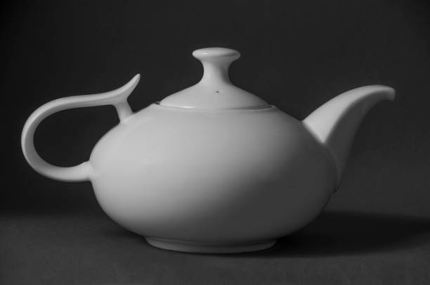 istock Porcelain teapot, white ceramic for brewing tea. Black and white. 1126379140