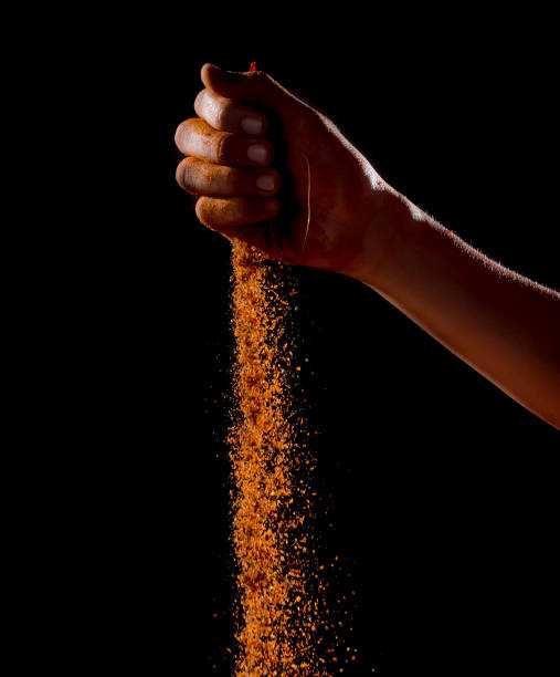istock Hand sprinkling cayenne pepper,cayenne pepper on dark background 1126379166