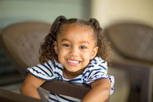 Cute mixed race little girl laughing and smiling. Portarit of a mixed race little girl laughing and smiling. 4 year old girl stock pictures, royalty-free photos & images