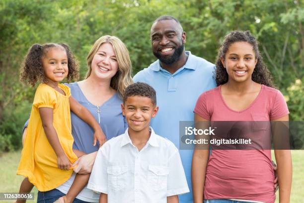 Portrait Of A Happy Mixed Race Family Smiling Stock Photo - Download Image Now - Family, Multiracial Group, Multiracial Person