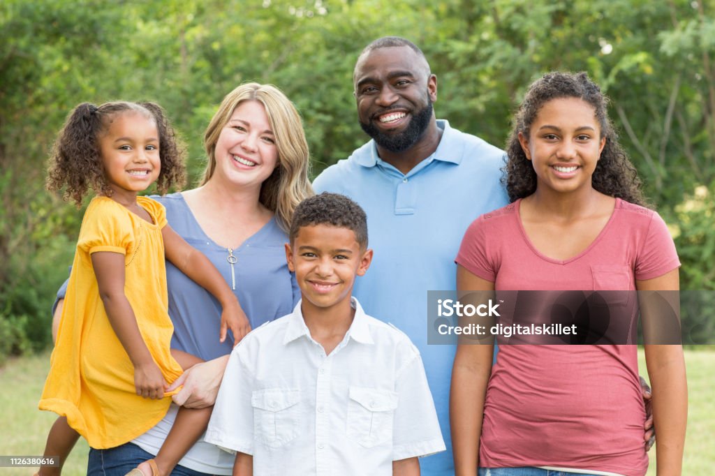 Retrato de uma família de raça mista feliz sorrir - Foto de stock de Família royalty-free