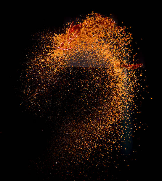 Cayenne pepper powder explosion isolated on black background,Flying Cayenne pepper,Motion blur