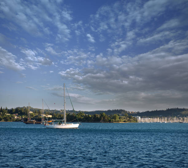 istock Sail boat sailing towards a touristic harbor, vacations and adventure concept 1126381405