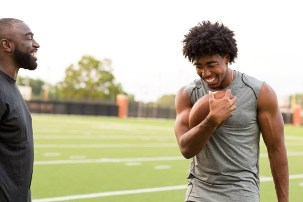 istock American Football coach training a young athlete. 1126382256