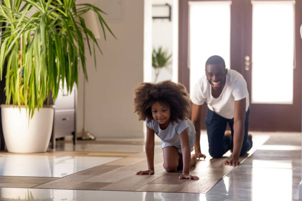istock African father and child crawling on floor playing at home 1126384505