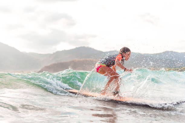 istock Little girl surfing 1126385457