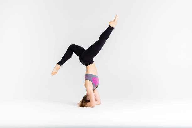 istock Young sportwoman stretching muscles on white background 1126385930