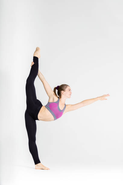 istock Young sportwoman stretching muscles on white background 1126387270