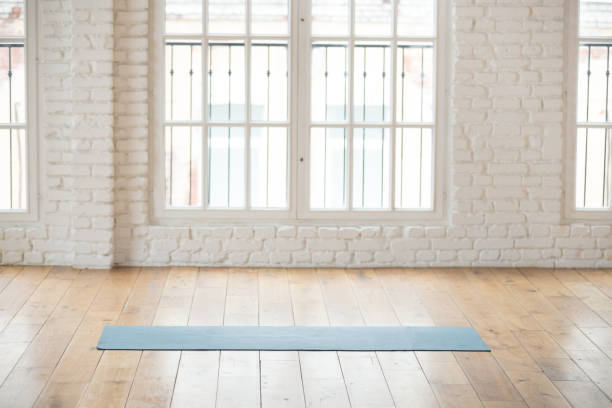 istock Unrolled yoga mat in empty fitness studio 1126387378