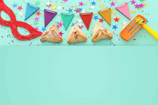 istock Purim celebration concept (jewish carnival holiday) over wooden mint background. 1126387430