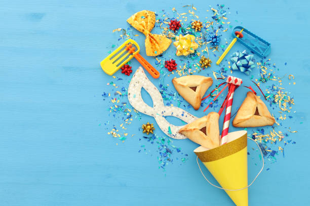 istock Purim celebration concept (jewish carnival holiday) over wooden blue background. 1126387469