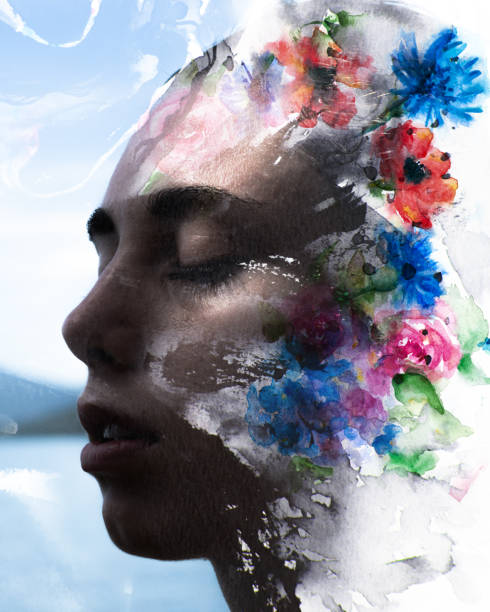 istock Paintography. Double exposure of a sensual peaceful model with strong features combined with hand drawn ink and watercolour paintings with floral motifs and an ocean background 1126387717