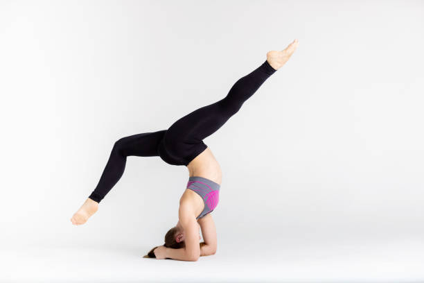istock Young sportwoman stretching muscles on white background 1126388653