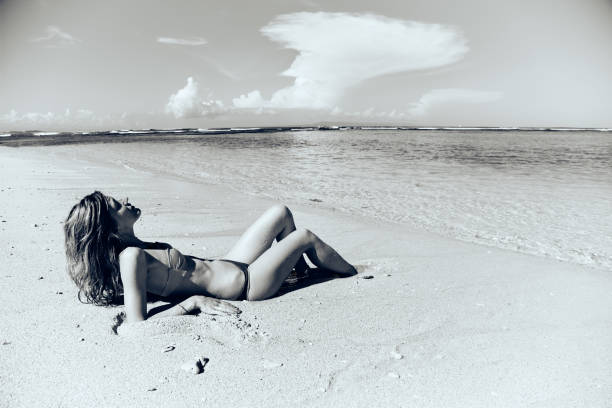 istock Slim woman enjoying on a sandy tropical beach. 1126389975