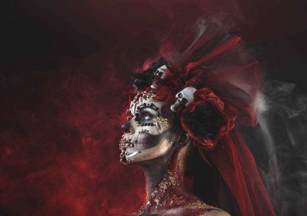 Young girl in the image of Santa Muerte Santa Muerte Young Girl with Artistic Halloween Makeup and with Sculls in her Hair muerte stock pictures, royalty-free photos & images