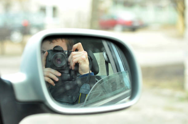 istock Reflection Of Man Photographing With Camera Seen In Side-View Mirror 1126390930