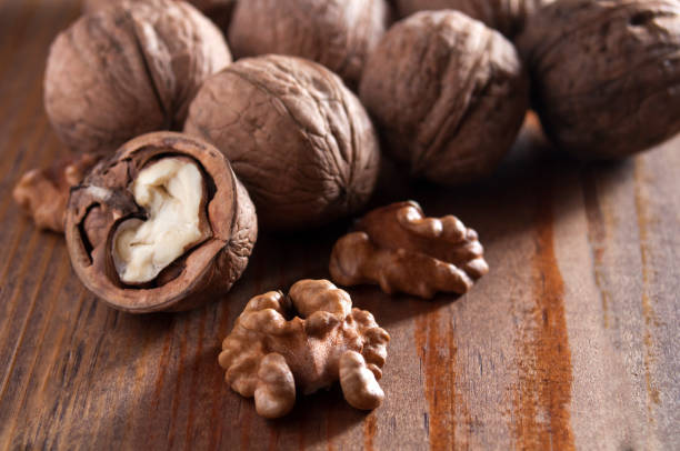 istock Walnuts on brown wooden table. Close-up. 1126396887