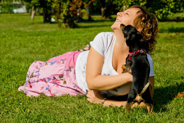 istock girl playing with dog 1126397451