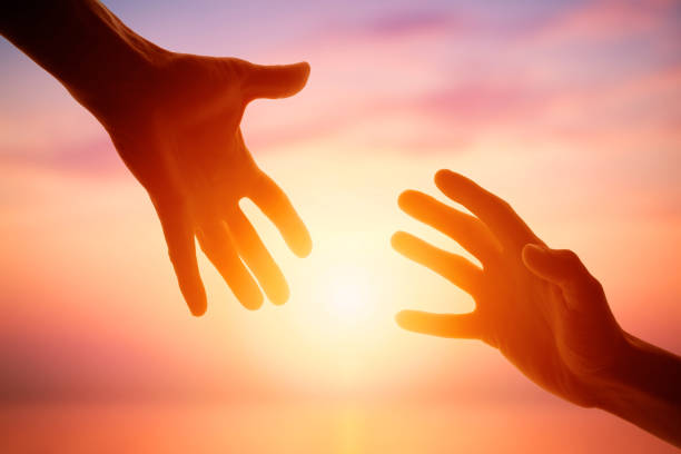 Giving a helping hand on the background of the dawn Giving a helping hand on the background of the dawn. Social life disabled person hiking outdoors stock pictures, royalty-free photos & images