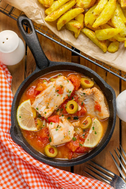 istock Cod fish cooked in tomato sauce with olives, lemon and tomato 1126399261