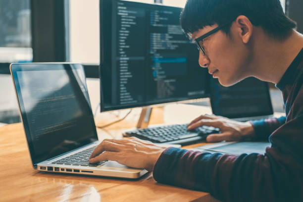 istock Side View Of Businessman Using Laptop At Desk In Office 1126399508