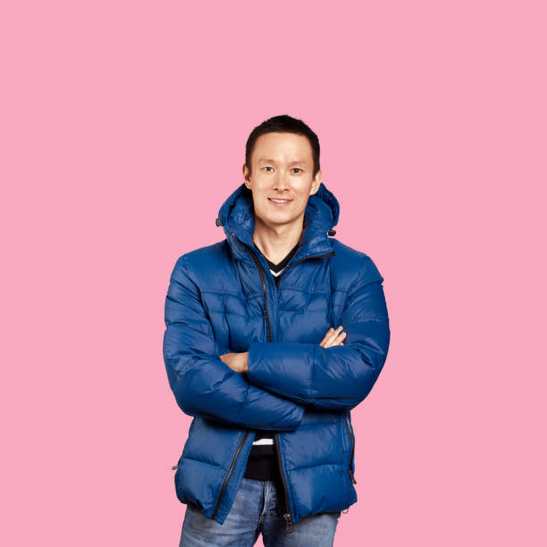 istock Asian man in blue down-padded coat, isolated on trendy gradient background 1126399568