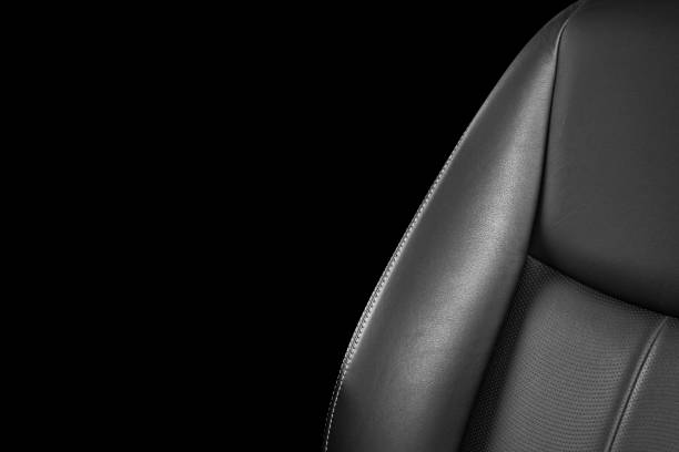 istock Black leather interior of a car. Perforated Leather comfortable seats with stitching isolated on black background. Car interior details. Car detailing. Car inside 1126400157