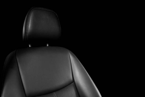 istock Black leather interior of a car. Perforated Leather comfortable seats with stitching isolated on black background. Car interior details. Car detailing. Car inside 1126400168
