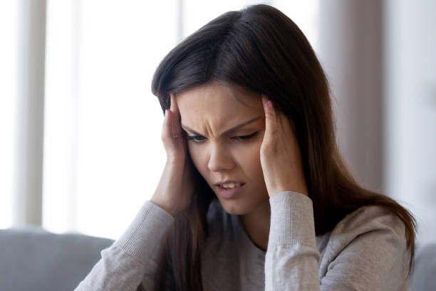 istock Upset stressed young woman feeling pain strong headache concept 1126400338