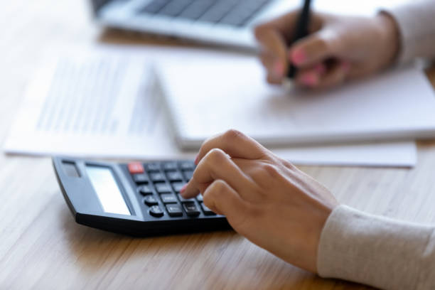 istock Female professional using calculator for business financial accounting, close up 1126400391