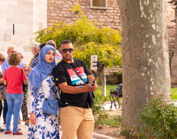 Young Turkish couple making a selfie in front of the main entrance of Topkapi Palace. Istanbul, Turkey, September 22nd, 2018: Young Turkish couple making a selfie in front of the main entrance of Topkapi Palace sonnenbrille stock pictures, royalty-free photos & images