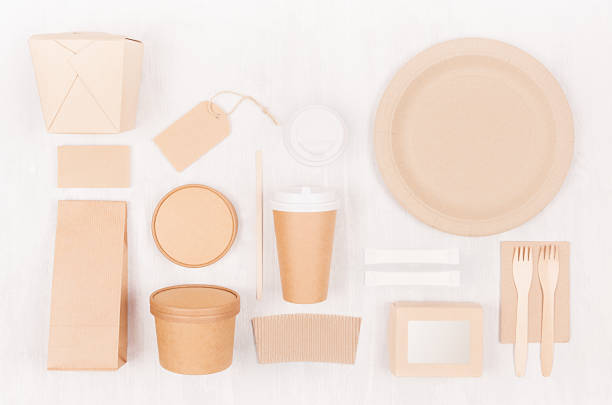 istock Blank different cardboard packaging for fast food - coffee cup, label, card, cutlery, sugar, spice, container and box for soup, sushi, noodles on white wood board. 1126401288