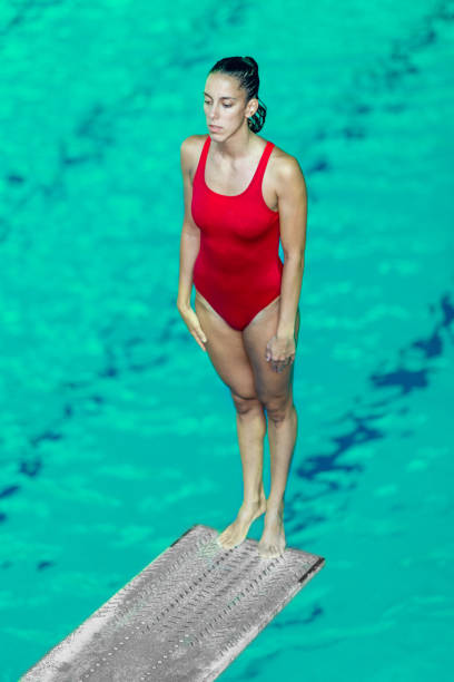 istock Swimmer Standing On Diving Platform Over Swimming Pool 1126401374