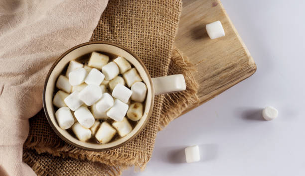 istock Mug of hot chocolate with candy marshmallows on table 1126401450