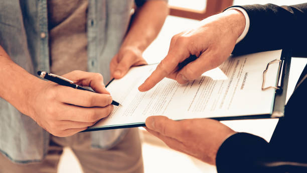 istock Man is Signing Contract for New Apartment 1126402335