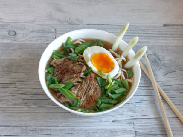 istock Ramen soup with fresh onions, boiled egg and fried meat 1126403900
