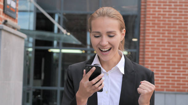 istock Walking and Celebrating Success Online on Smartphone 1126404263