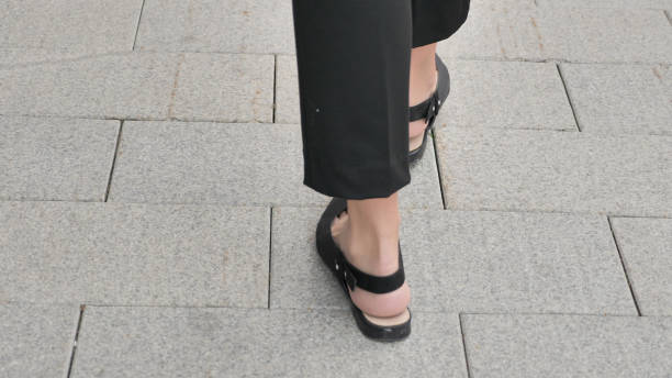 istock Back View of Walking Female Feet 1126404369