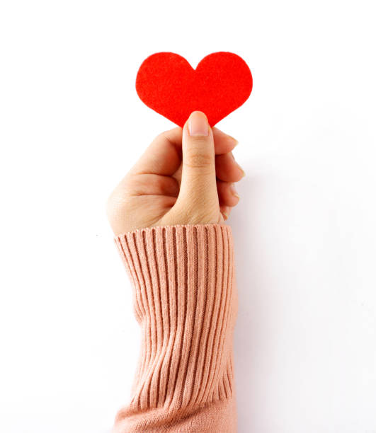 istock Female hand holding Red  hearts on a white background 1126407179