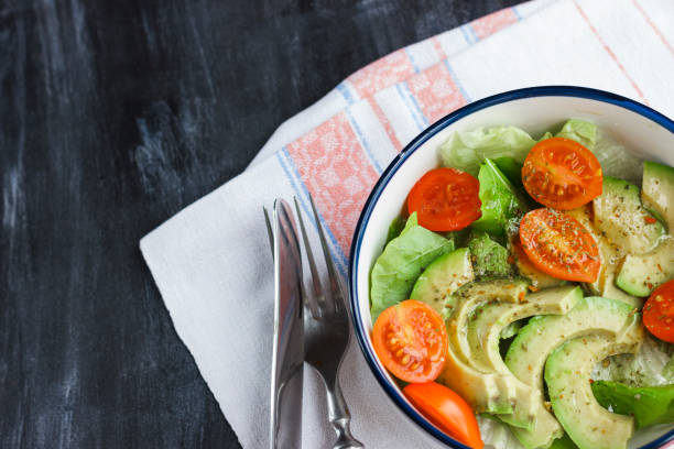 istock Vegetarian salad with avocado, arugula, cherry tomatoes and herbs. 1126407664