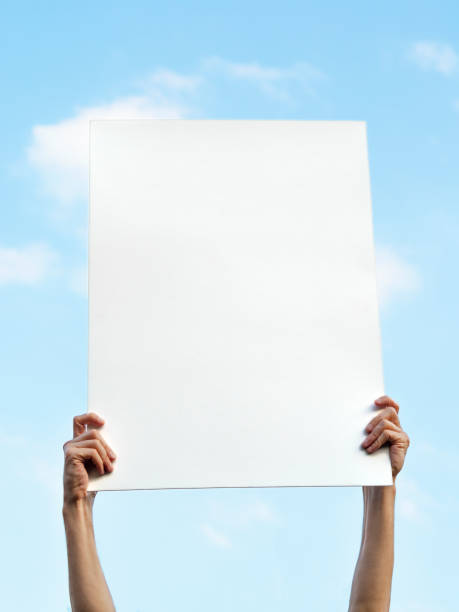 istock man holding up the poster,blank billboard 1126407718