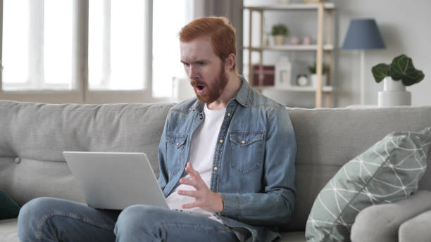 istock Shocked Creative Beard Man Working on Laptop, Astonished 1126408108