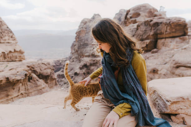 istock Woman petting kitten near Petra 1126410192