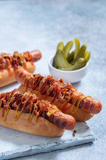 istock Hot Dog With Yellow Mustard, Onion, Bacon 1126411415