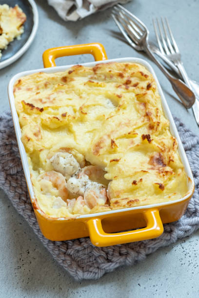 Fish pie topped with mashed potato Fish pie with shrimp topped with mashed potato fish pie stock pictures, royalty-free photos & images