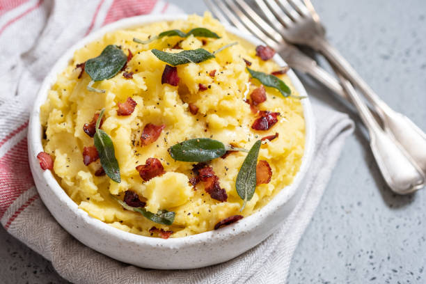 Mashed potatoes with crispy bacon and sage Mashed potatoes with crispy bacon and sage in a bowl mashed potatoes stock pictures, royalty-free photos & images