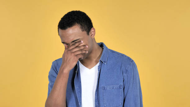 istock Sad Upset Young African Man Isolated on Yellow Background 1126412177