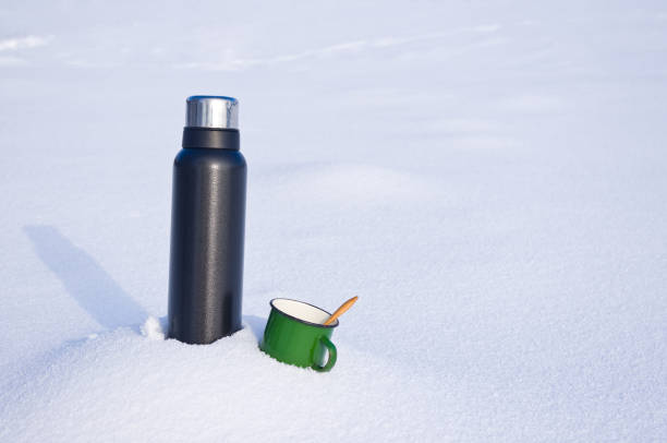 istock Thermos and mug in the snow 1126412191