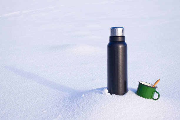 istock Thermos and mug in the snow 1126412193