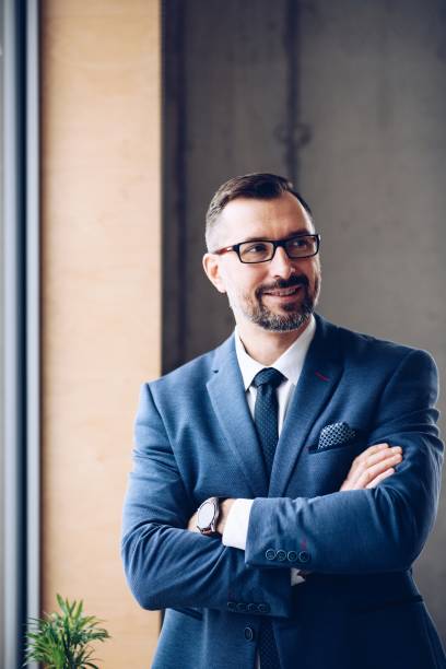 istock 40 years old handsome businessman in suit at office 1126412420